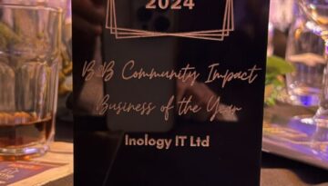 Inology IT team holding the Tameside Business Awards trophy for B2B Community Impact Business Of The Year 2024