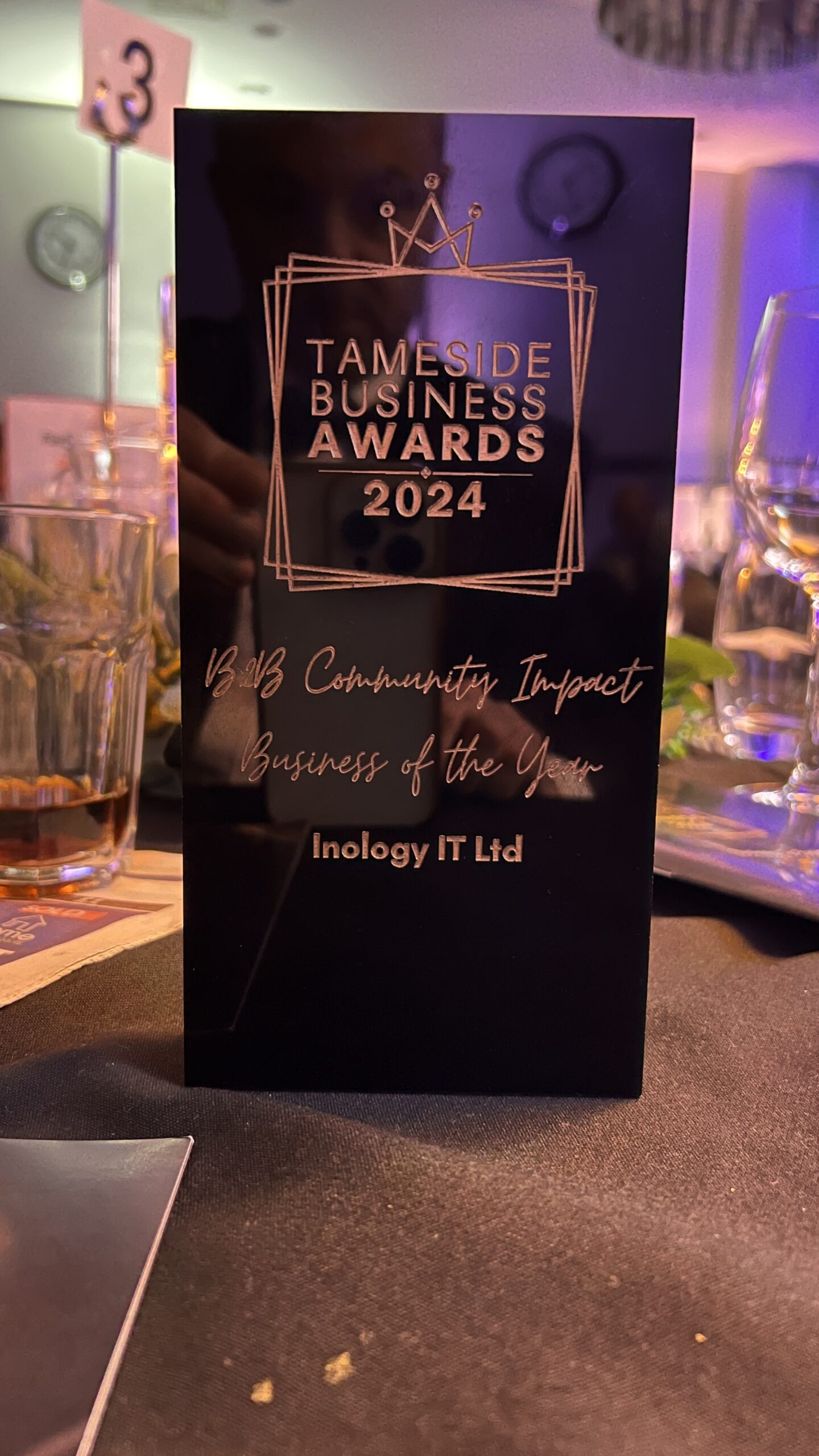 Inology IT team holding the Tameside Business Awards trophy for B2B Community Impact Business Of The Year 2024